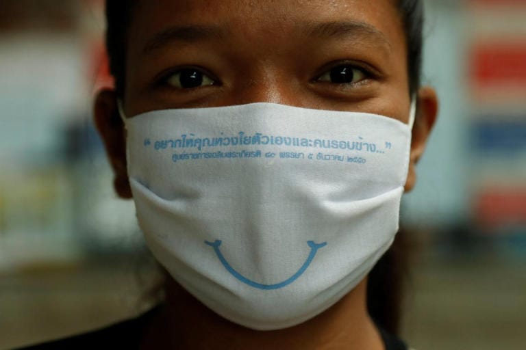 حیرت انگیز تھائی لینڈ زائرین کا چہرہ ماسک کے پیچھے خوبصورت مسکراہٹ کے ساتھ خیرمقدم کرتا ہے